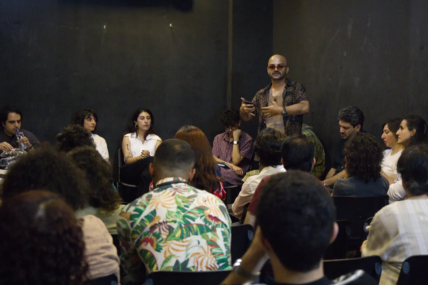 A speaker addressing the full room during the conversation encounter.