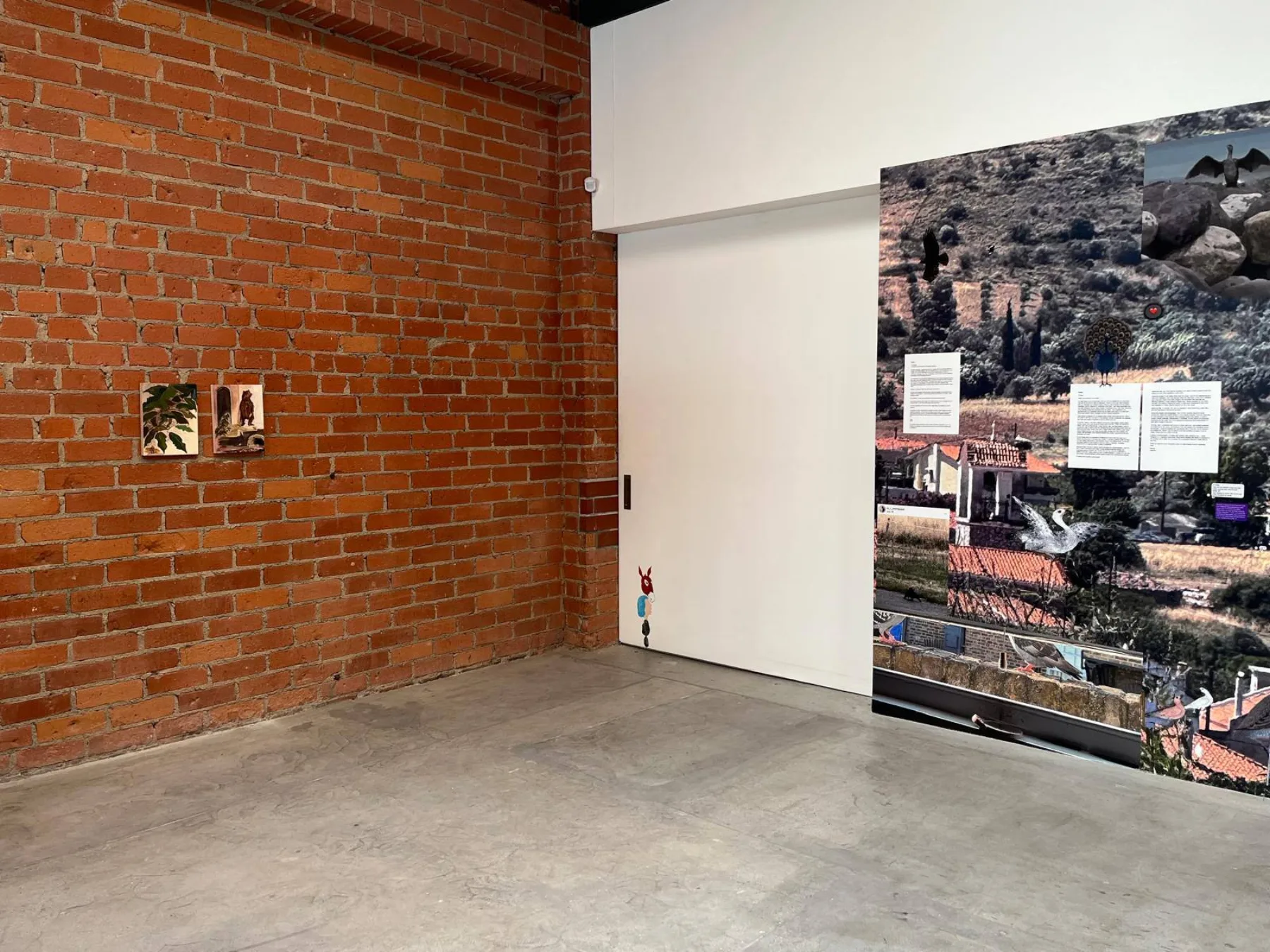 A neighboring wall piece in the group exhibition beside the installation.