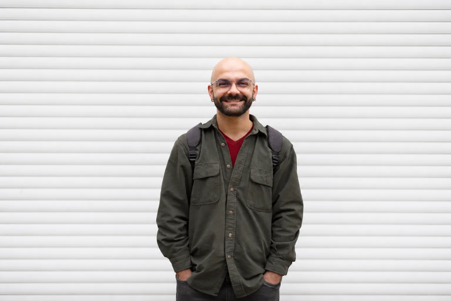 Hodjat Salimi standing in front of a white wall.